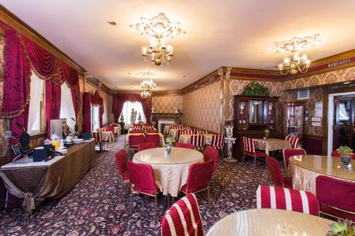 a dining room with tables and chairs and chandeliers at Queen Anne in San Francisco