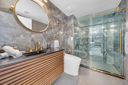 a bathroom with a sink and a mirror at Sunbeam Plush 2 Story Loft in Miami