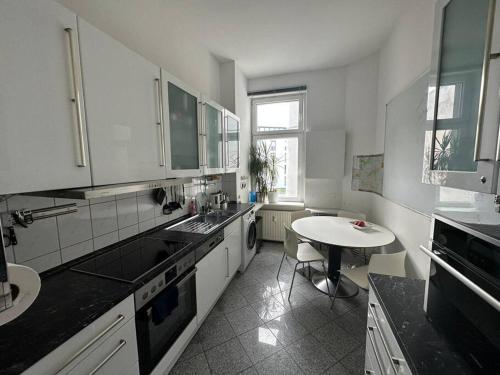 a kitchen with a sink and a table in it at Business apartment in Berlin in Berlin