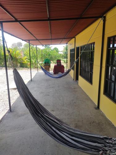 a hammock hanging from a building in a building at Casa Vacacional Quinta Sofia in Girardot