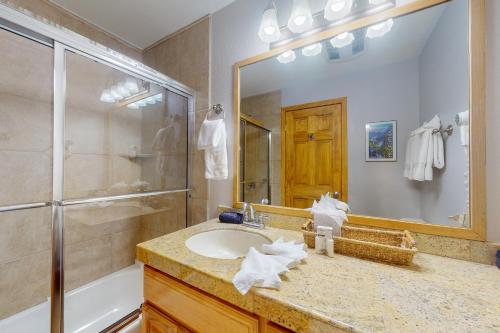 a bathroom with a sink and a shower and a mirror at Pine Ridge 05E in Breckenridge