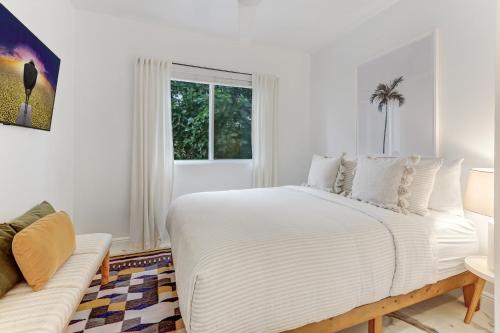 a white bedroom with a large bed and a window at ArTease5 - stylish, near Wynwood Walls & restaurants in Miami