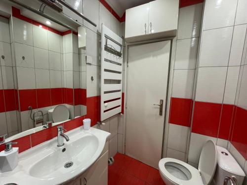 a bathroom with a white sink and a toilet at Vintage Delight Apartment Vracar Hram Sv Save in Belgrade