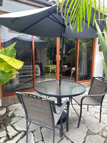 a table and chairs with an umbrella on a patio at Casa Miura Hotel Boutique in Ajijic