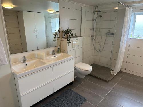 a bathroom with a sink and a toilet and a shower at Selið Farm Stay - Guesthouse 