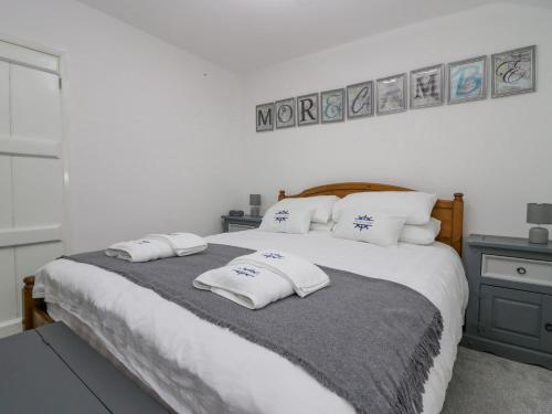 a bedroom with a large bed with pillows on it at The Bay Cottage - Morecambe Bay in Morecambe