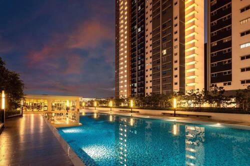 a large swimming pool in front of some buildings at KLIA Homestay Apartment - 2 room in Sepang