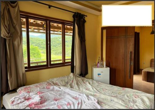 a bedroom with a bed with a window and a dresser at Casa Lazer&Tranquilidade @lazer.tranquilidade in Brumadinho