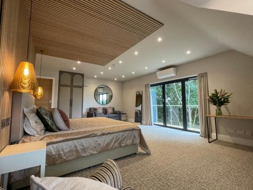 a large bedroom with a bed and a large window at The Boutique Hotel in Faringdon