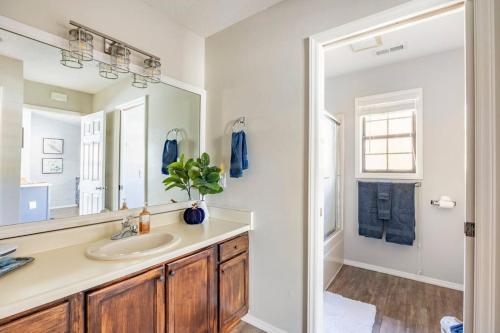 a bathroom with a sink and a mirror at Creekside Gated Golf Mtn Villa w/fast wifi & paved in Franklin
