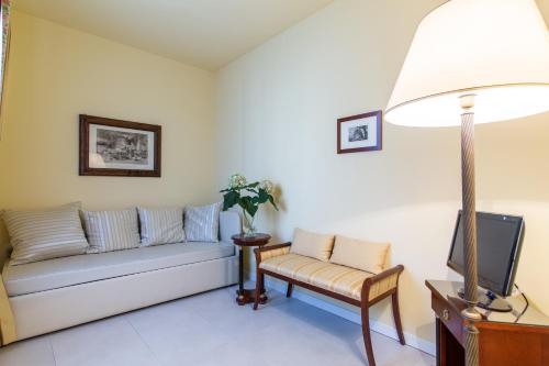 a living room with a couch and a tv at Hotel Sant'Andrea in Ravenna