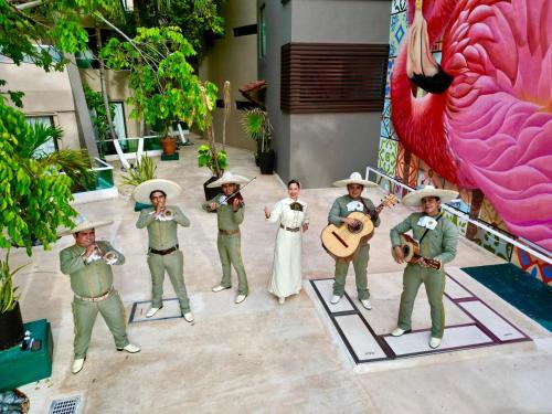 a group of men in green uniforms playing music at Flamingo Cancun All Inclusive in Cancún