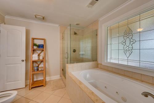 a bathroom with a tub and a shower and a toilet at Milledgeville Home with Private Dock and Dock House! in Milledgeville