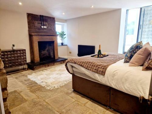 a bedroom with a large bed and a fireplace at Hamilton - Lord William in Scorton