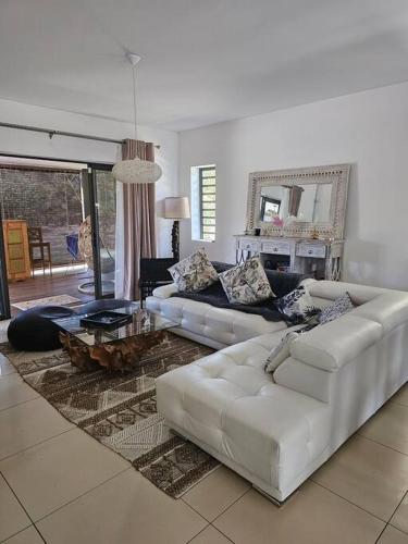 a living room with two white couches and a table at Private Secured 4 Bedroom Villa in Grand-Baie