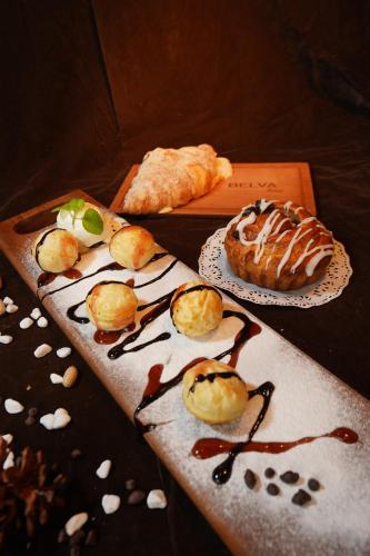 a table with two plates of pastries and bread at BELVA huis in Bogor