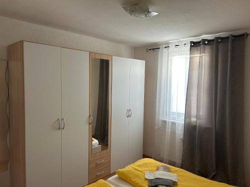 a bedroom with a bed and a dresser and a mirror at Wohnung VS in Villingen-Schwenningen