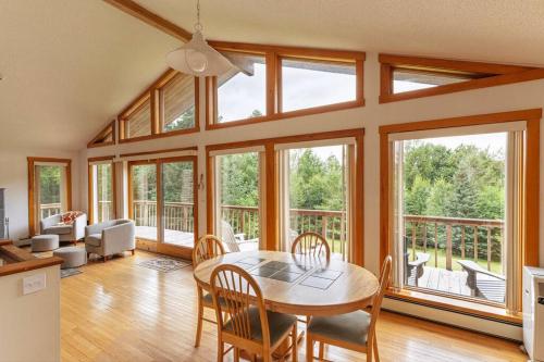 a living room with a table and chairs and windows at Campbell Estates in Franklin