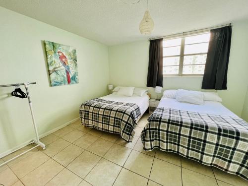 a room with two beds and a lamp in it at Oceanview Beachfront Condo on Tides Resort in Hollywood
