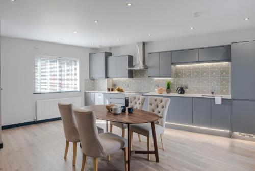 a kitchen with a wooden table and chairs in a room at Barley Vale - Your Apartment in Bristol