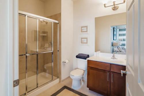 a bathroom with a shower and a toilet and a sink at The Loft Life 3BR in NYC! in New York
