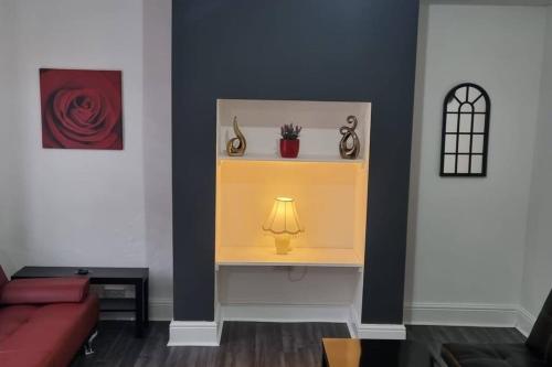 a room with a yellow shelf with a lamp on it at Be our Guest! Stylish-Central location-Comfy-Cosy in Headingley