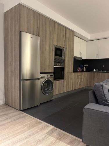 a kitchen with a stainless steel refrigerator and a microwave at Zena Park in Odivelas