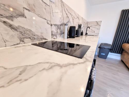 a marble counter top in a kitchen with a sink at Kaoglen Lodge - Fawn Pod - Hot Tub - Dogs - Pitlochry - Luxury in Blairgowrie