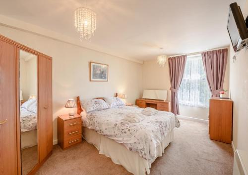 a bedroom with a large bed and a window at Upcott Cottage Upcott House in Barnstaple