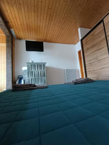 a room with a bed and a television in it at Appartamento lake-side in Calceranica al Lago