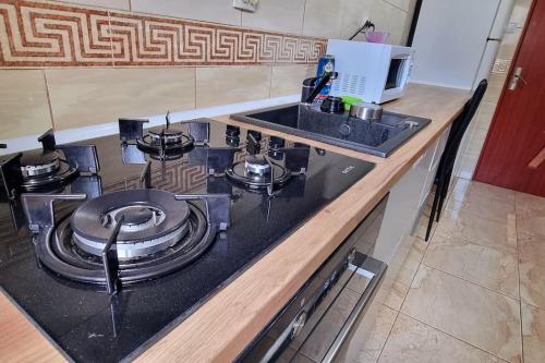 a kitchen counter with a stove and a sink at Urban Retreat Barlad in Bîrlad