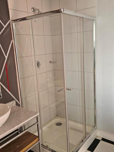 a shower with a glass door in a bathroom at @Derricks Luxury Apartments 2 in Johannesburg