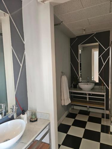 a bathroom with two sinks and a mirror at @Derricks Luxury Apartments 2 in Johannesburg