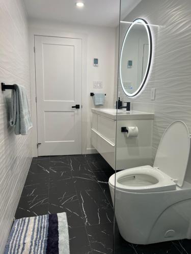a bathroom with a white toilet and a mirror at The Croft House - 2 Bedroom 1 Bathroom Suite in Burlington