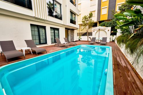 a swimming pool in front of a building at Lilium Boutique Hotel in Antalya