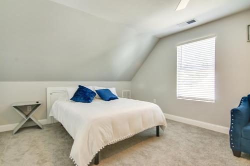 a bedroom with a bed with blue pillows on it at Updated Home - Walk to Salisbury University! in Salisbury