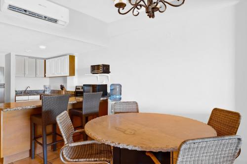 a kitchen with a wooden table and chairs at Anclote 5103 in Punta Mita