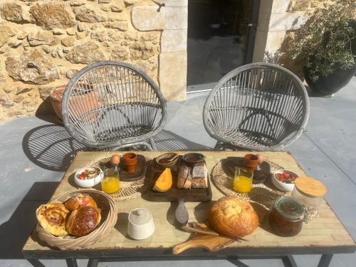 a tray of food on a table with two chairs at Le Mas Li Jasso in Piolenc