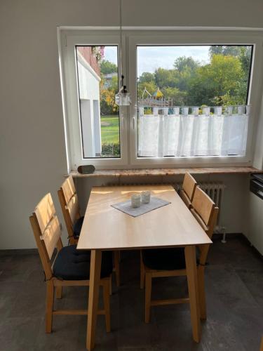uma mesa de jantar com 2 cadeiras e uma janela em Ferienwohnung in ruhiger Lage em Thurnau
