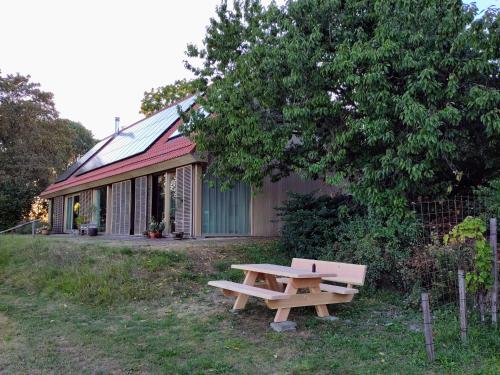 a picnic table in front of a building with a tree at De Kinkhoorn in Ezinge
