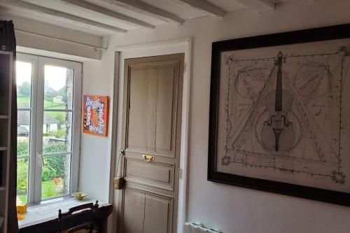 a room with a door and a picture on the wall at Au cœur de Mortagne, un balcon sur le Perche in Mortagne-au-Perche