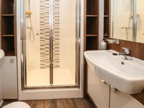 a bathroom with a shower and a sink at Loch Lomond Holiday Home in Arrochar