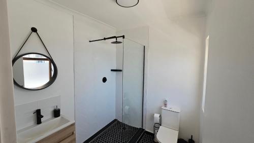 a bathroom with a glass shower and a mirror at WunderLux in Cape Town