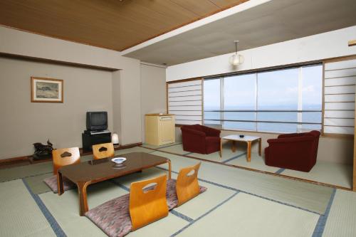 a living room with a table and chairs at Ibusuki Seaside Hotel in Ibusuki