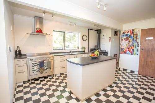 a kitchen with a checkered floor at Westholm Lodge in Harihari