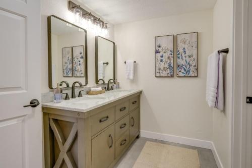 a bathroom with a sink and a mirror at Fully Renovated Phoenix Condo with Pool-View Balcony in Phoenix