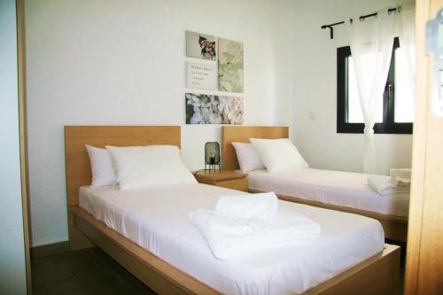 a bedroom with two beds with white sheets at DakarByDays-DBD004-Appartement Amina 3 chambres in Dakar