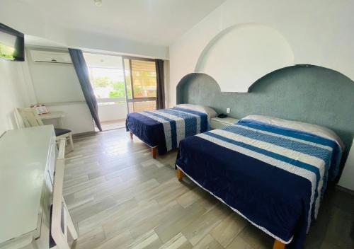 Posteľ alebo postele v izbe v ubytovaní Hotel La Cascada