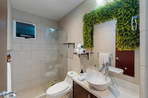 La salle de bains est pourvue de toilettes, d'un lavabo et d'une télévision. dans l'établissement Ciudad del Mar#20, à Jacó