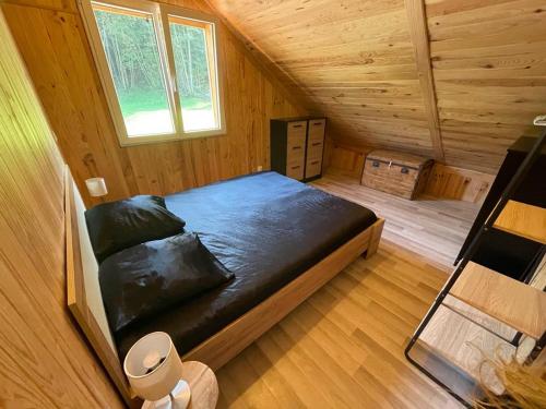a bedroom with a bed in a wooden cabin at Chalet Nala in La Bresse